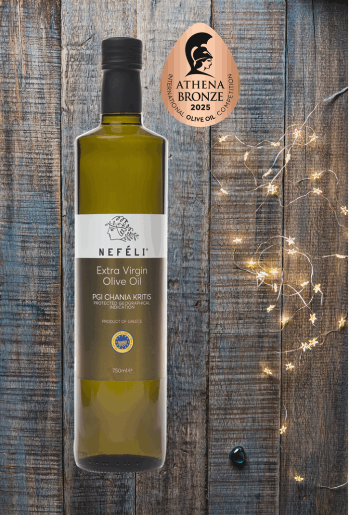 Bottle of Nefeli Extra Virgin Olive Oil PGI Chania Kritis with Athena Bronze 2025 award seal and festive background lights